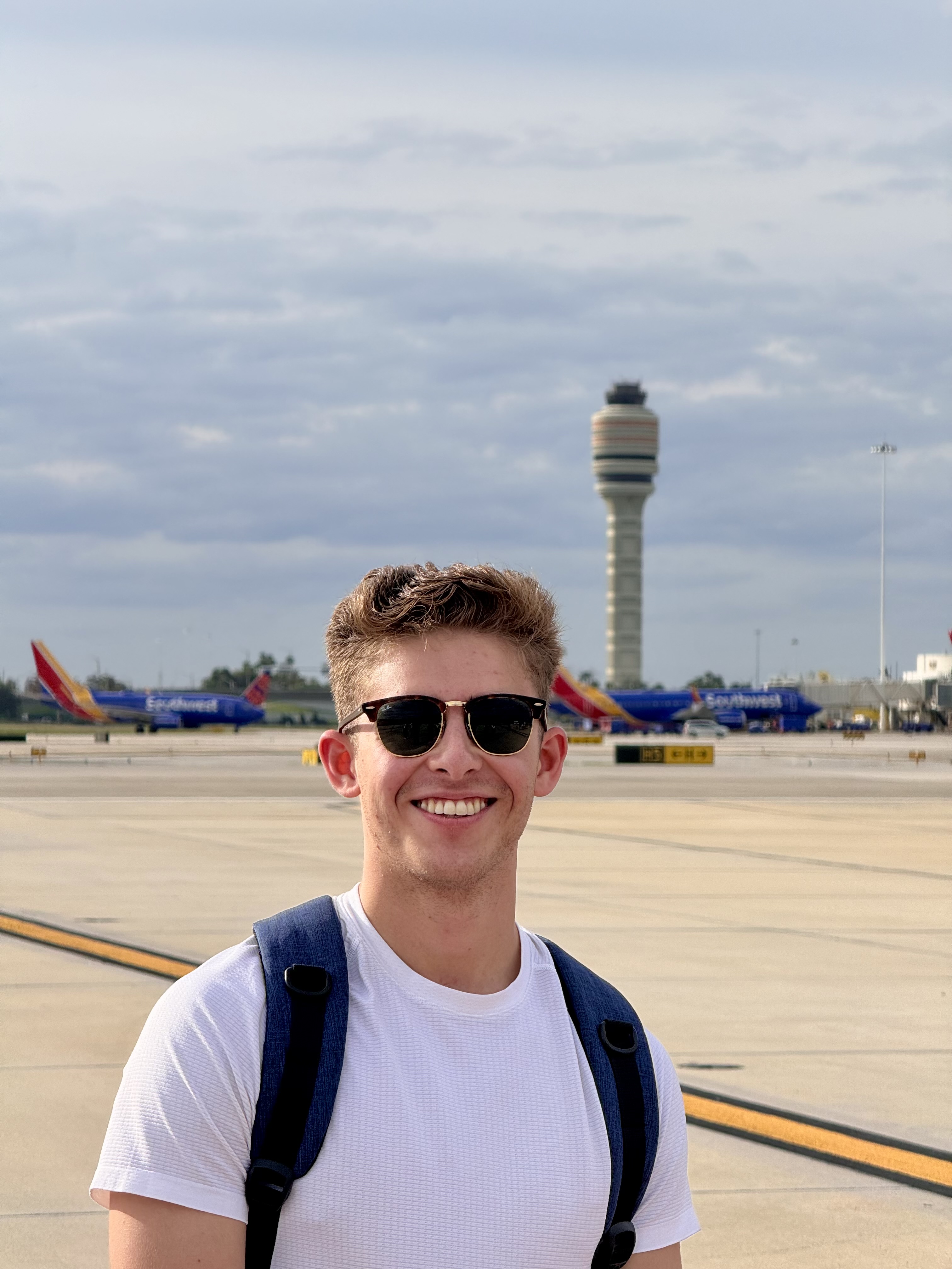 Sebastian Alvarenga on the MCO ramp with control tower behind him